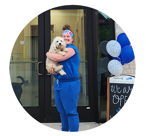Dr. Kayla Miller, Veterinarian Dr. Kayla Miller, veterinarian at Flowery Branch Animal Hospital, holding a dog outside the veterinary practice